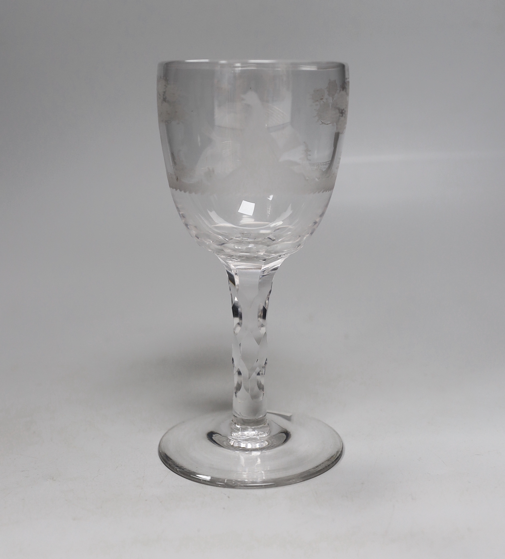 An English lead crystal facet stem goblet, c.1780, round funnel bowl, with hexagonal facet stem, conical foot, engraved in the round with trees and cock fighting scenes, 18.6cm